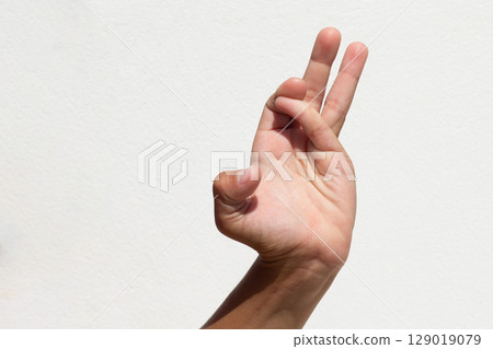 Child demonstrating finger flexibility by crossing index and little fingers Child demonstrating finger flexibility by crossing index and little fingers 129019079