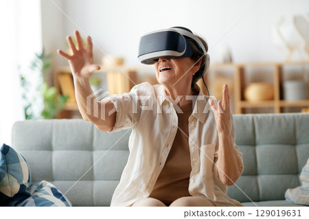 woman playing console games wearing vr goggles woman playing console games wearing vr goggles 129019631