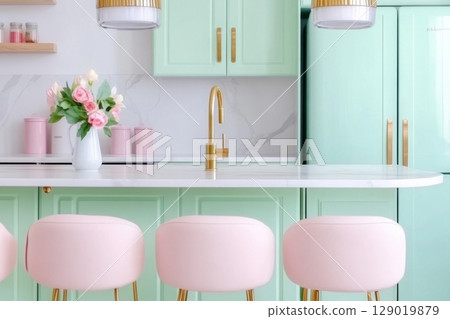 Modern kitchen design featuring pastel mint cabinets and soft pink decor with white marble countertops enhancing a serene atmosphere 129019879