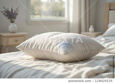 Soft Beige Pillow on a Brightly Lit Bed Soft Beige Pillow on a Brightly Lit Bed 129020529
