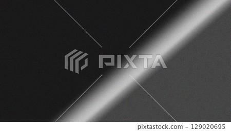 Diagonal gradient grainy background with smooth transition from black to gray creating dynamic abstract noise texture design 129020695