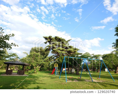 Playground equipment and rest areas in the park 129020740