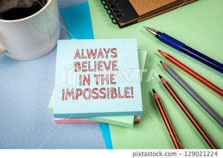 ALWAYS BELIEVE IN THE IMPOSSIBLE. Inspirational Message on Sticky Note Surrounded by Office Supplies ALWAYS BELIEVE IN THE IMPOSSIBLE. Inspirational Message on Sticky Note Surrounded by Office Supplies 129021224