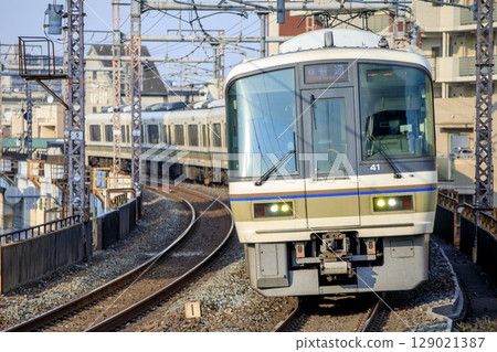 A 221 series train running around a curve near Teradacho Station on the Osaka Loop Line A 221 series train running around a curve near Teradacho Station on the Osaka Loop Line 129021387