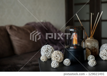 Close up of home perfume scent air humidifier with light. Aromatherapy holistic health practices concept. Stress relief activities preparing for meditation. Simple pleasures healing 129021491