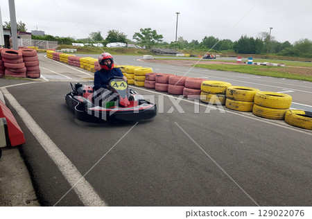 Person go-karting on a motor racing track Person go-karting on a motor racing track 129022076