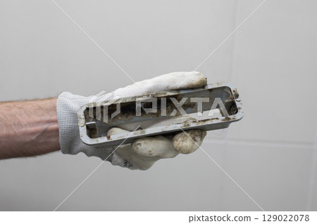 Bathroom drain with mildew and dirt in plumber hand 129022078