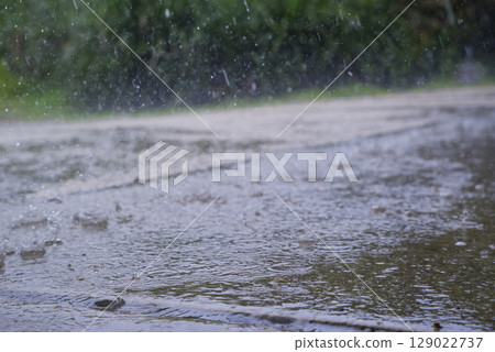 Raindrops hitting the paved road Raindrops hitting the paved road 129022737