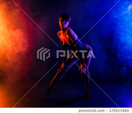 Dominatrix Woman In Sexy Corset Dancing In Colorful Pink Light. Mistress, Fetish Dominatrix Woman In Sexy Corset Dancing In Colorful Pink Light. Mistress, Fetish 129023860