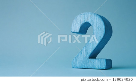 blue number two wooden block on light blue background 129024020