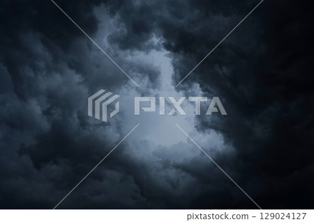 Dark blue storm clouds before rain. Bad weather, darkness, death. 129024127