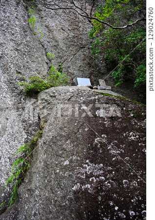 Stone Buddha statue on a huge rock at Kagikake in the Misaka Mountains Stone Buddha statue on a huge rock at Kagikake in the Misaka Mountains 129024760