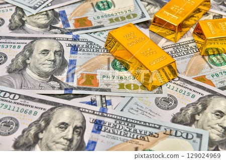 Paper us 100 dollar bill with gold bars, concept of investment and saving, wealth 129024969