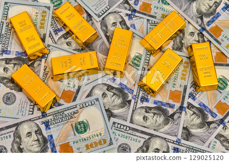 Paper us 100 dollar bill with gold bars, concept of investment and saving, wealth Paper us 100 dollar bill with gold bars, concept of investment and saving, wealth 129025120