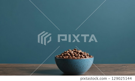blue bowl of dog food on wooden table blue bowl of dog food on wooden table 129025144