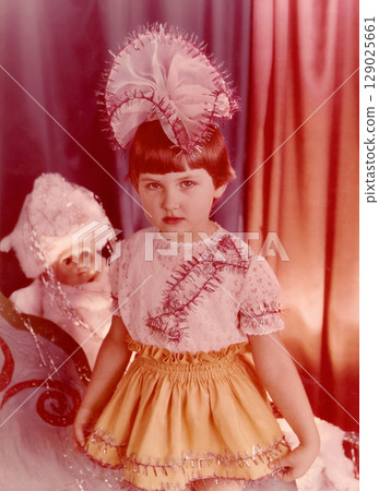 Soviet girl of two or three years old with a bow on her head at Christmas in kindergarten Soviet girl of two or three years old with a bow on her head at Christmas in kindergarten 129025661