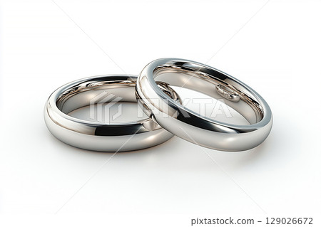 Pair of white gold wedding rings on a white background. Pair of white gold wedding rings on a white background. 129026672