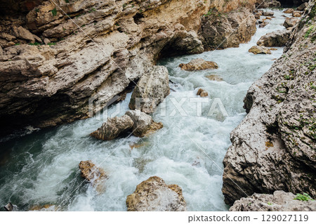 Bubbling mountain river in forest landscape 129027119