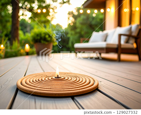Summer veranda and mosquito coils – A charming sunset scene generated by AI 129027332