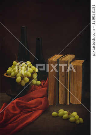 Still life with grapes, old books and bottles 129028181