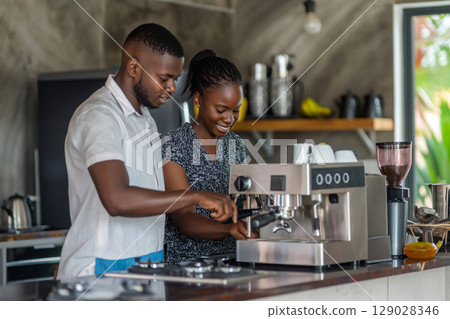 Two baristas working together, preparing a coffee using a professional coffee machine in a modern coffee shop 129028346