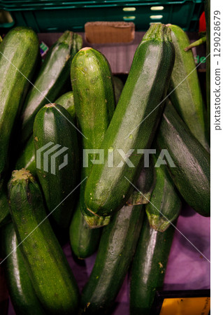 Fresh and Vibrant Zucchini Displayed in a Market Setting Showcasing the Bright Green Colors of These Healthy Vegetables Packed with Nutrients and Culinary Potential Fresh and Vibrant Zucchini Displayed in a Market Setting Showcasing the Bright Green Colors of These Healthy Vegetables Packed with Nutrients and Culinary Potential 129028679