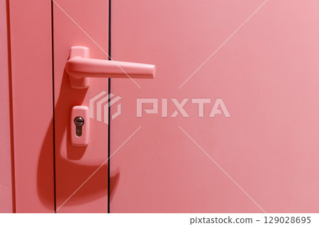 A Close-Up View of a Pink Door with a Unique Handle and Lock Mechanism, Perfectly Reflecting Modern Design Trends in Interior Architecture and Aesthetic Appeal A Close-Up View of a Pink Door with a Unique Handle and Lock Mechanism, Perfectly Reflecting Modern Design Trends in Interior Architecture and Aesthetic Appeal 129028695