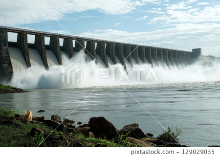 Powerful water jets are gushing out of the dam, generating renewable energy 129029035