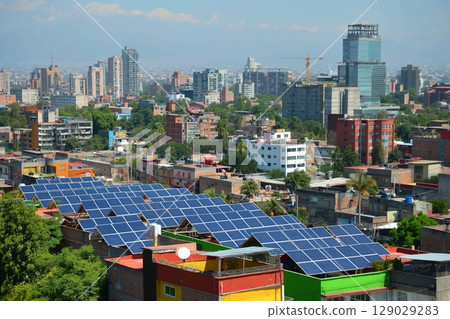 Rows of solar panels are installed on rooftops, transforming sunlight into electricity in a densely populated urban setting 129029283