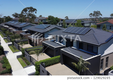 Modern suburban homes are utilizing solar panels on their roofs, showcasing a commitment to renewable energy and sustainable living 129029285