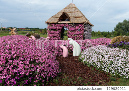 A Whimsical Garden Scene Featuring Colorful Flowers with Charming Decorations and Scenic Landscape Elements, Perfect for Nature Lovers and Garden Enthusiasts Alike A Whimsical Garden Scene Featuring Colorful Flowers with Charming Decorations and Scenic Landscape Elements, Perfect for Nature Lovers and Garden Enthusiasts Alike 129029911