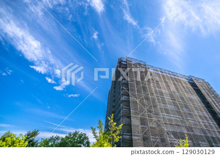 Yokohama cityscape in Japan: Summer sky spreads out... View of scaffolding and protective nets for repairs and inspections of apartment buildings (July 27th) 129030129