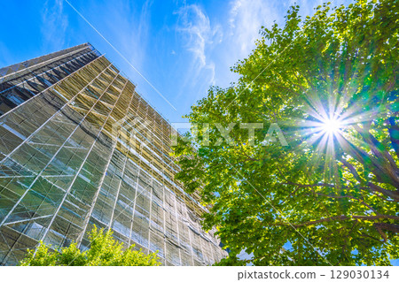 Yokohama cityscape in Japan: Summer sky spreads out... View of scaffolding and protective nets for repairs and inspections of apartment buildings (July 27th) 129030134