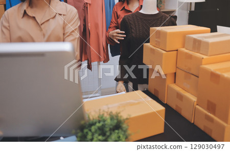 Portrait of Starting small businesses SME owners, two Asian woman check online orders Selling products working with boxs freelance work at home office, sme business online small medium enterprise 129030497