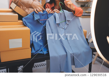 Portrait of Starting small businesses SME owners, two Asian woman check online orders Selling products working with boxs freelance work at home office, sme business online small medium enterprise 129030516