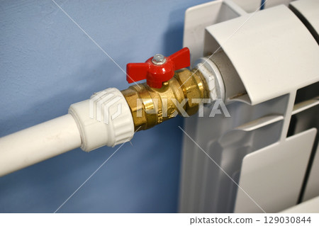A water radiator for heating. A white radiator for indoor heating. 129030844