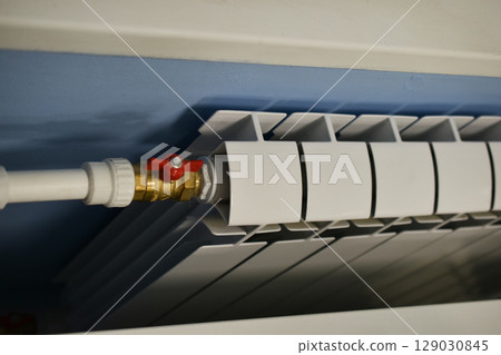 A water radiator for heating. A white radiator for indoor heating. 129030845