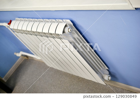 A water radiator for heating. A white radiator for indoor heating. A water radiator for heating. A white radiator for indoor heating. 129030849