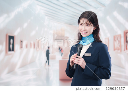 A woman giving a commentary at an art museum 129030857