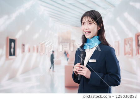 A woman giving a commentary at an art museum 129030858