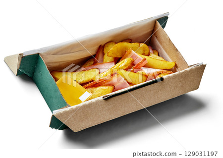 Cardboard takeaway box filled with roasted potato wedges, ham and cheese on white background Cardboard takeaway box filled with roasted potato wedges, ham and cheese on white background 129031197