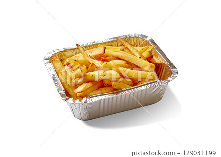 French fries with spices served in an aluminum tray on white background French fries with spices served in an aluminum tray on white background 129031199