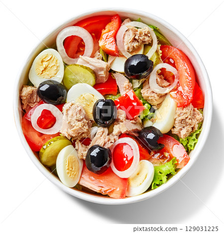 Tuna salad with lettuce, tomatoes, eggs, black olives and gherkins in white bowl 129031225