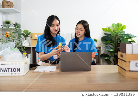 Volunteers collaborating on donation efforts, sharing ideas 129031389