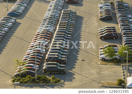 View from above of dealers outdoor parking lot with many brand new cars in stock for sale. Concept of development of american automotive industry 129031595