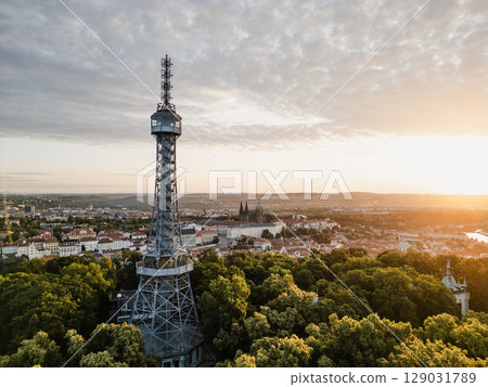 Beautiful sunrise illuminates Petrin Lookout Tower and Prague Castle, casting a golden glow over the city of Prague. This breathtaking view captures the historical charm of the area. Beautiful sunrise illuminates Petrin Lookout Tower and Prague Castle, casting a golden glow over the city of Prague. This breathtaking view captures the historical charm of the area. 129031789