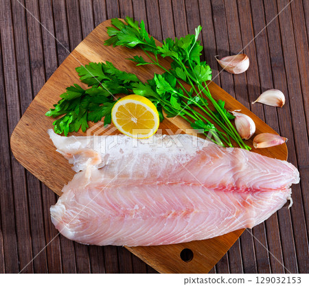 Image of fillet of raw perch fillet before cooking with greens Image of fillet of raw perch fillet before cooking with greens 129032153