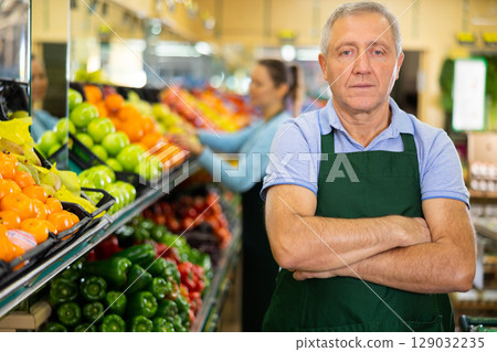 vegetable salesman in supermarket 129032235