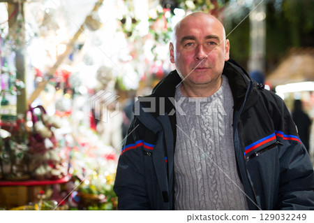 Portrait of a confident man who came to the Christmas fair 129032249