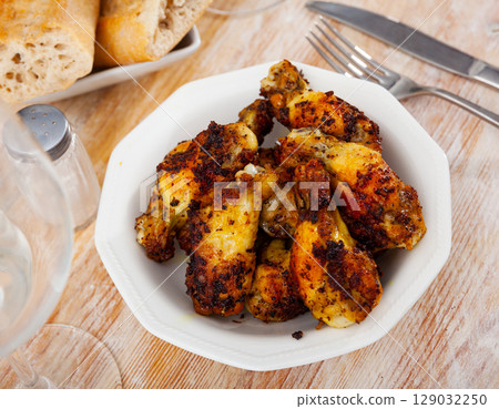 Tasty spicy deep fried unbreaded chicken wings 129032250